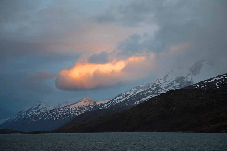 Sun on clouds at sunset on Antarctic peninsula.